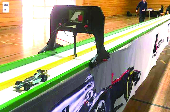 The cars travelled the length of a mini racetrack in between 1 and 2 seconds.